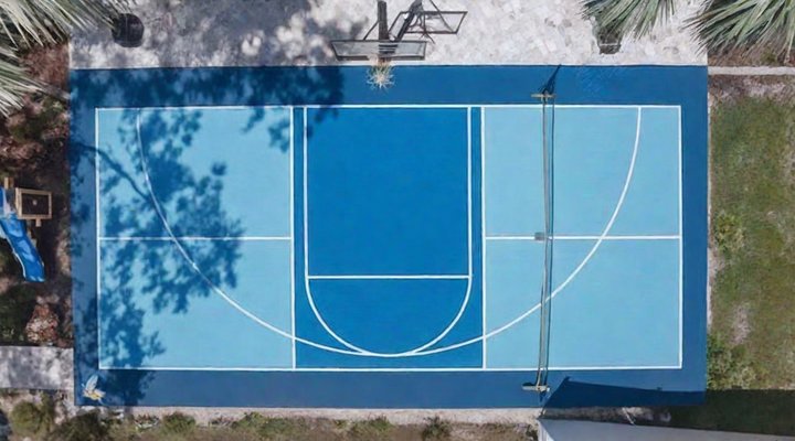 Top-down view of a fresh blue pickleball court on a GR build